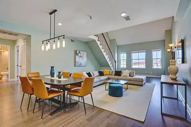 a living room with fireplace furniture and a wooden floor