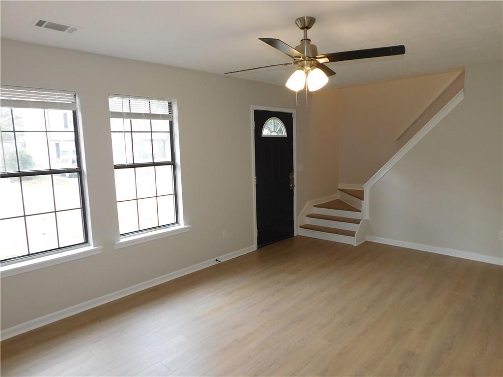 3589 North Hopkins Court Powder Springs, GA 30127 - Photo 4 of 17 wooden floor in an empty room with a window