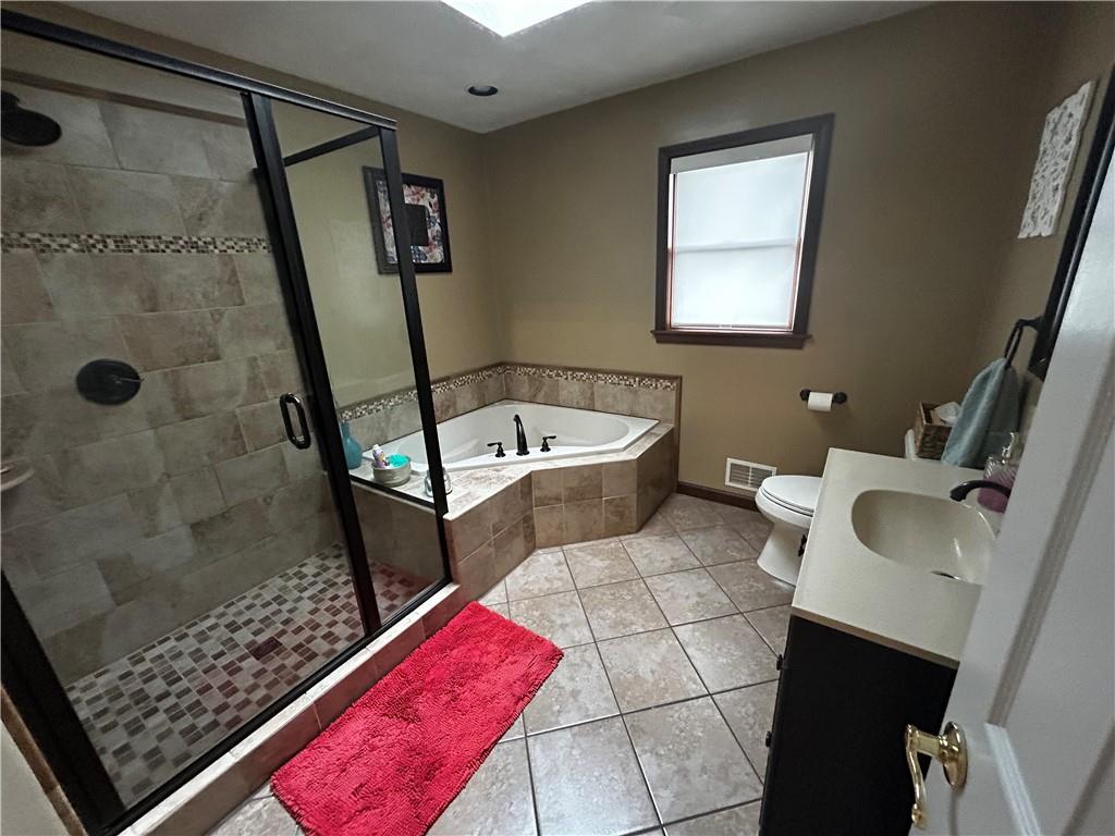22 Dawn Drive Indiana, PA 15701 - Photo 16 of 27 a bathroom with a sink a toilet a mirror and shower