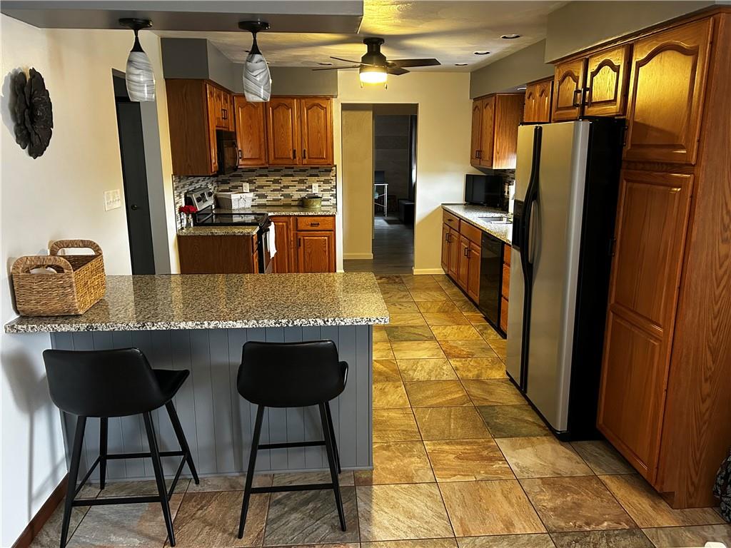22 Dawn Drive Indiana, PA 15701 - Photo 6 of 27 a kitchen with stainless steel appliances granite countertop a sink stove and refrigerator