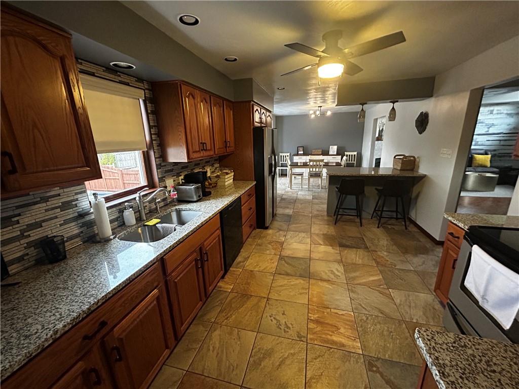 22 Dawn Drive Indiana, PA 15701 - Photo 8 of 27 a kitchen with stainless steel appliances granite countertop sink stove and cabinets