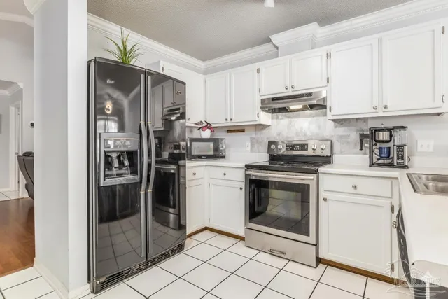 a kitchen with a refrigerator sink and cabinets