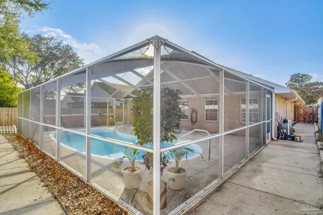 a view of a swimming pool with outdoor seating