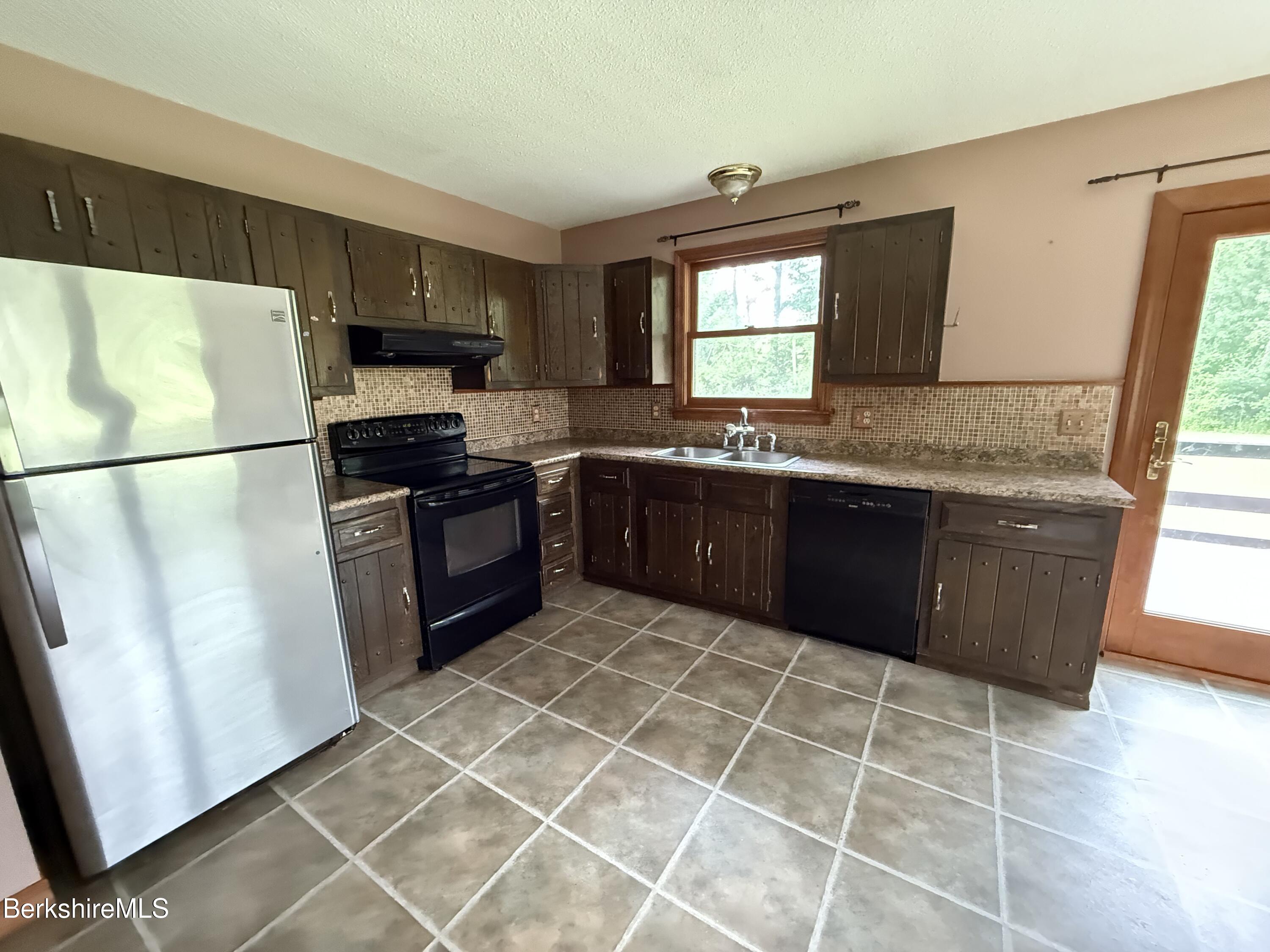 153 East Dugway Road Lenox, MA 01240 - Photo 12 of 26 a kitchen with stainless steel appliances granite countertop a stove a sink and a refrigerator