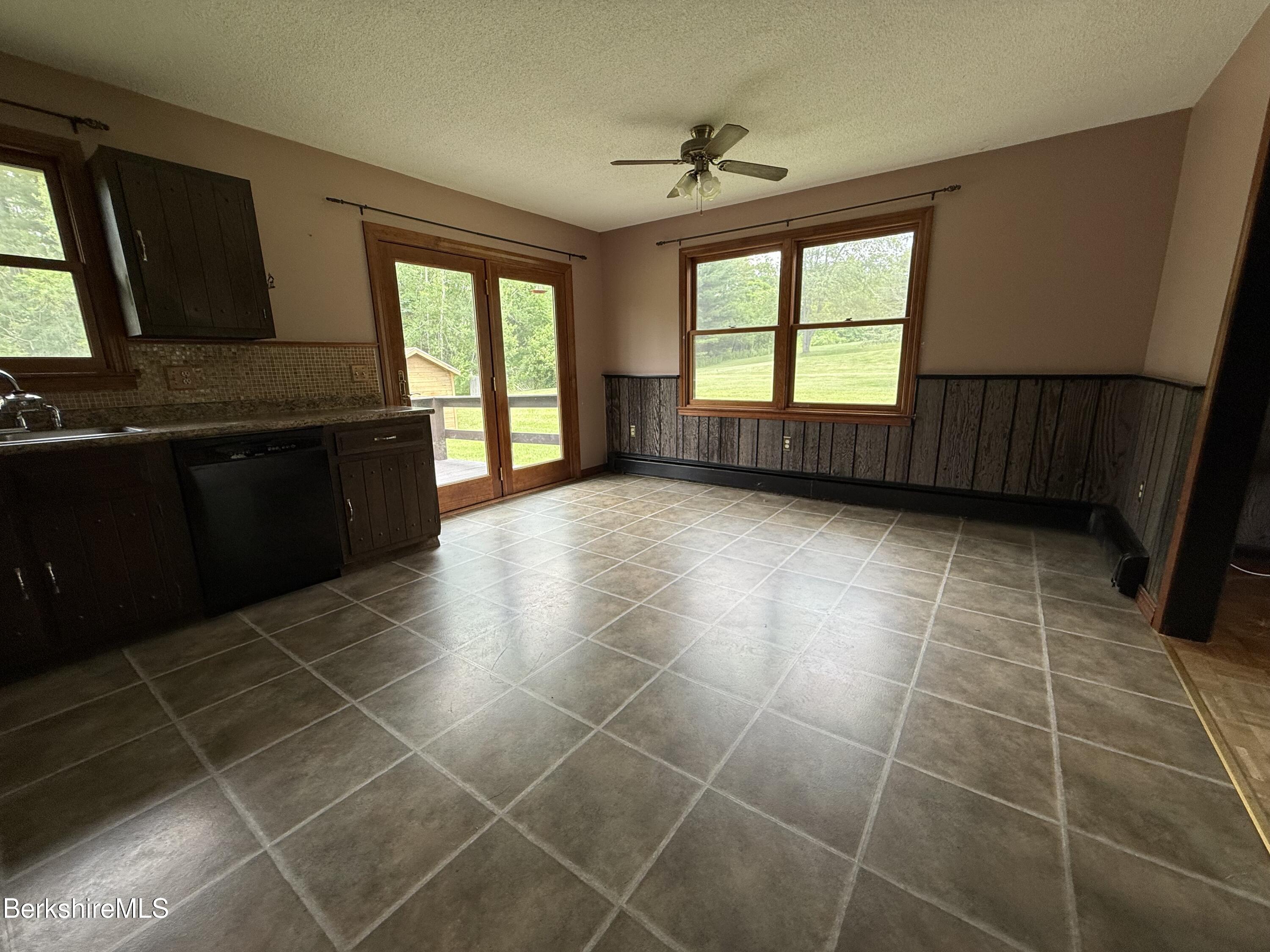 153 East Dugway Road Lenox, MA 01240 - Photo 13 of 26 a view of a kitchen with a sink wooden cabinets and outdoor space