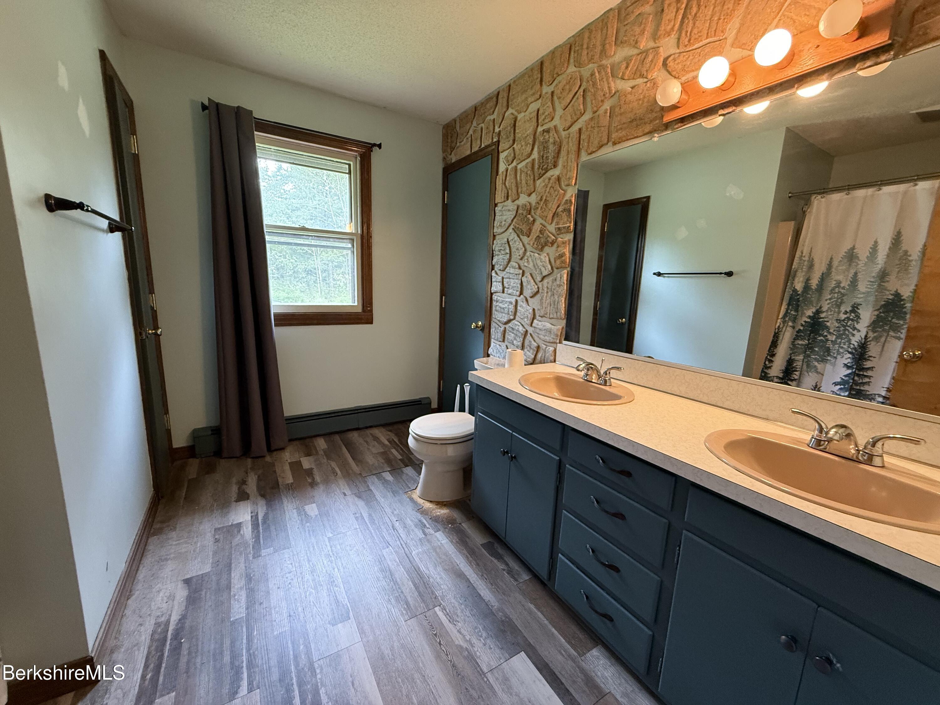 153 East Dugway Road Lenox, MA 01240 - Photo 14 of 26 a bathroom with a double vanity sink and a mirror