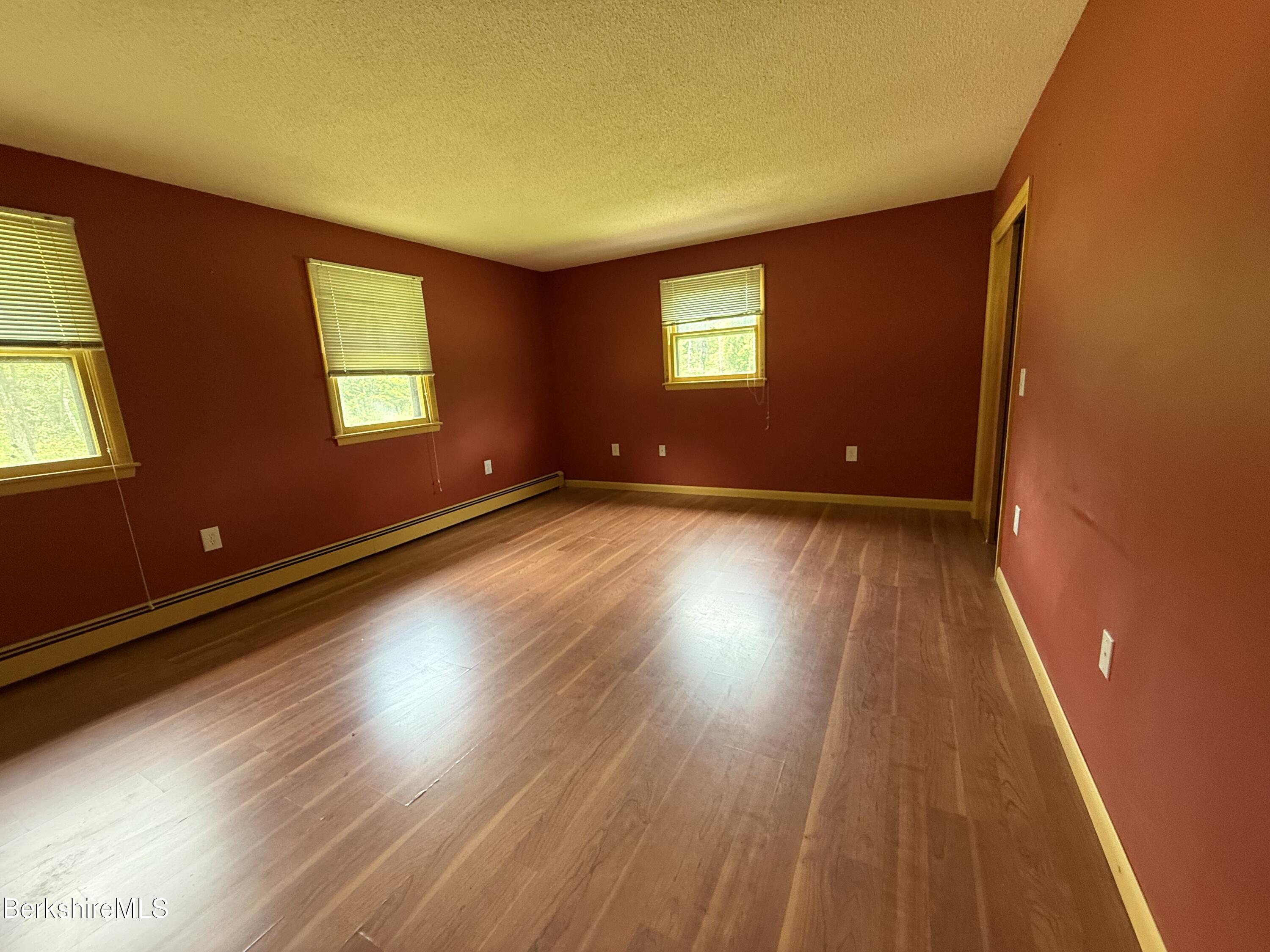 153 East Dugway Road Lenox, MA 01240 - Photo 15 of 26 a view of an empty room with wooden floor and a window