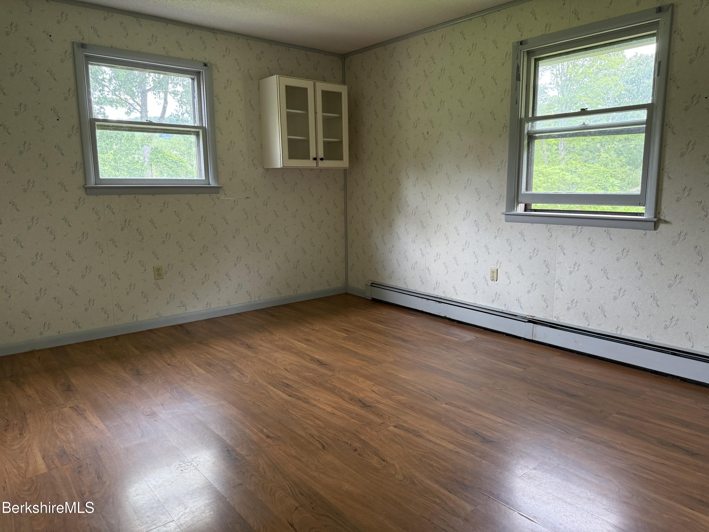 153 East Dugway Road Lenox, MA 01240 - Photo 17 of 26 an empty room with wooden floor and windows