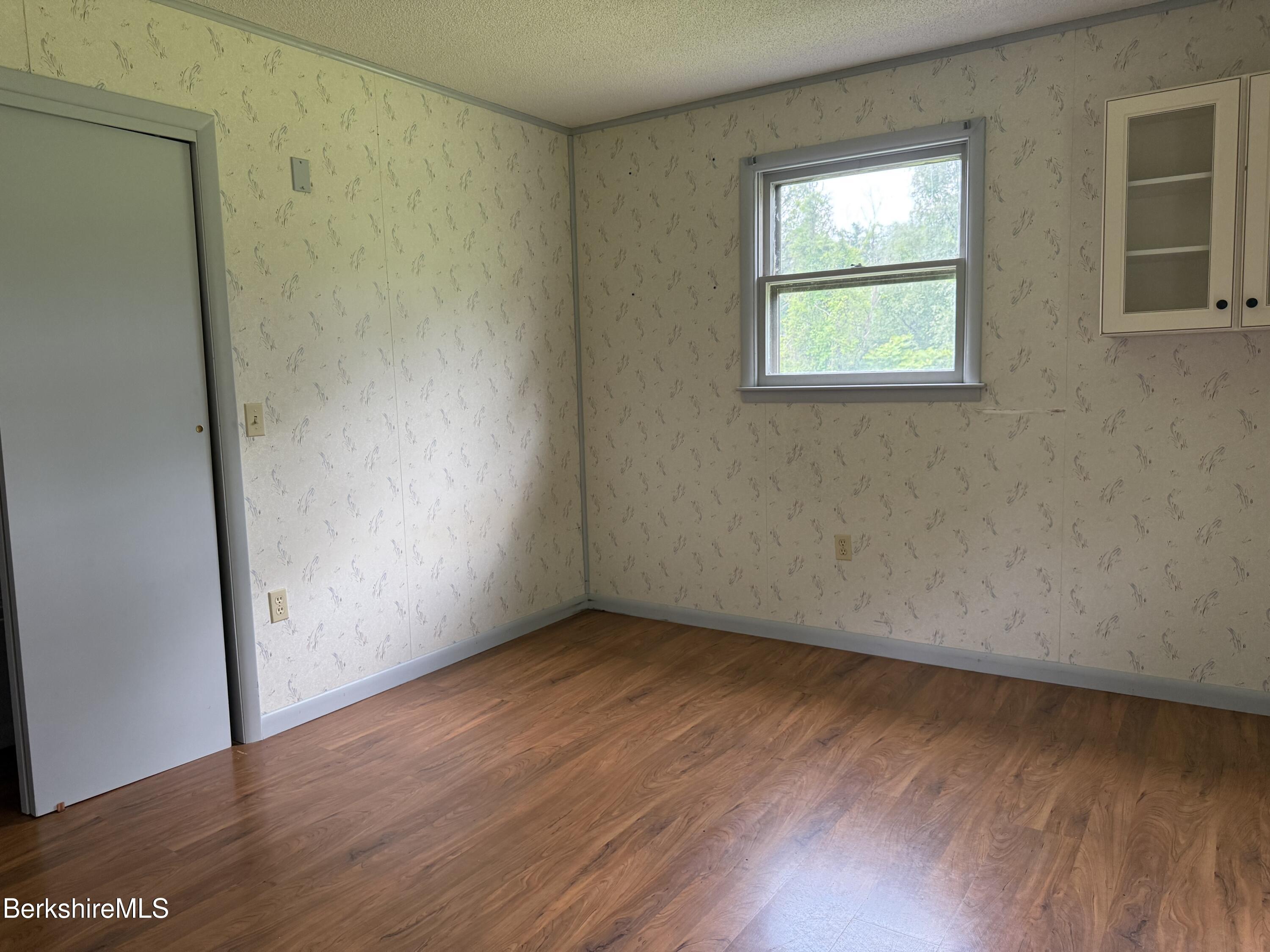153 East Dugway Road Lenox, MA 01240 - Photo 18 of 26 an empty room with wooden floor and windows