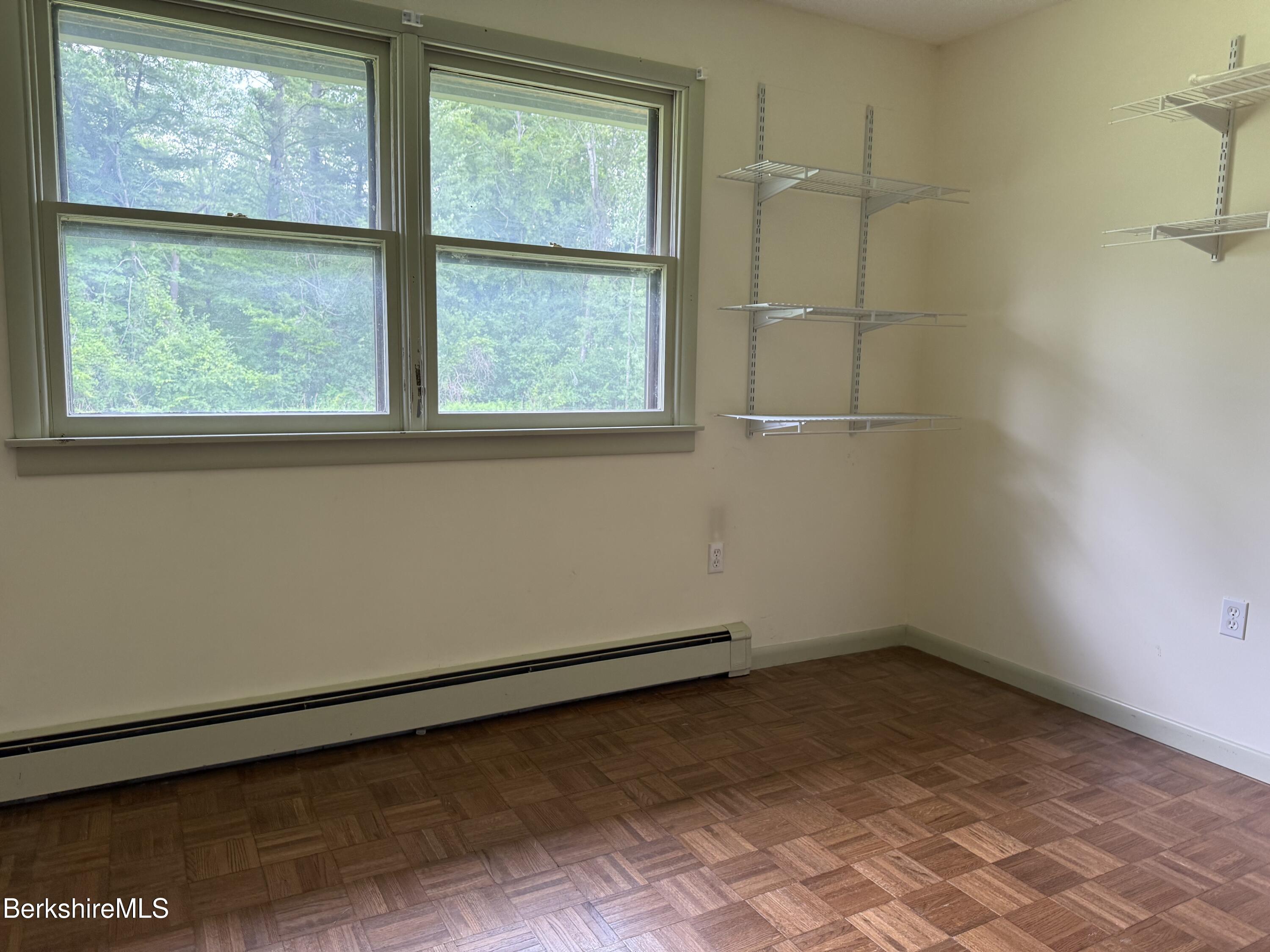 153 East Dugway Road Lenox, MA 01240 - Photo 19 of 26 a view of a small space with wooden floor and a window
