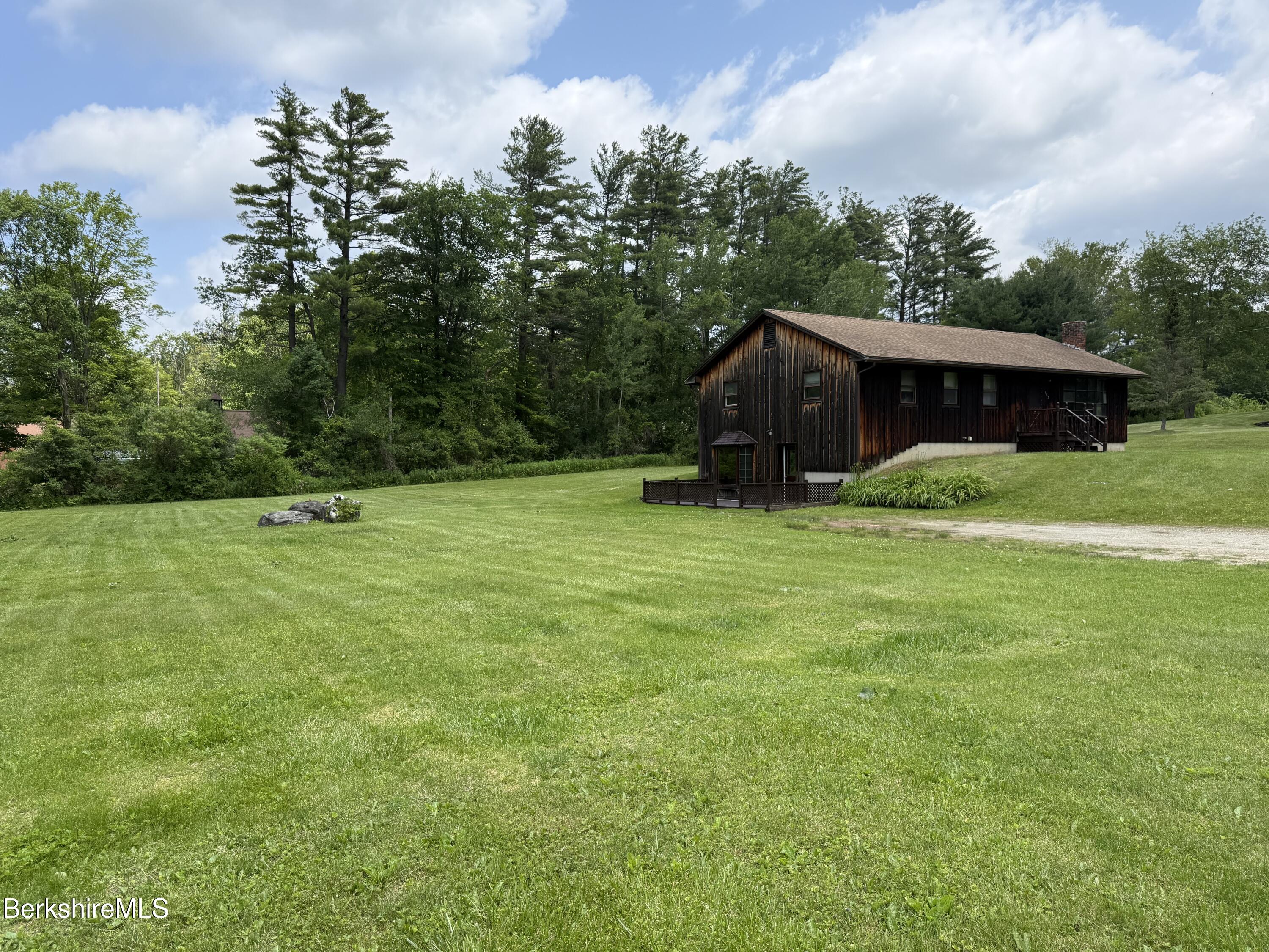 153 East Dugway Road Lenox, MA 01240 - Photo 2 of 26 a backyard of a house with lots of green space