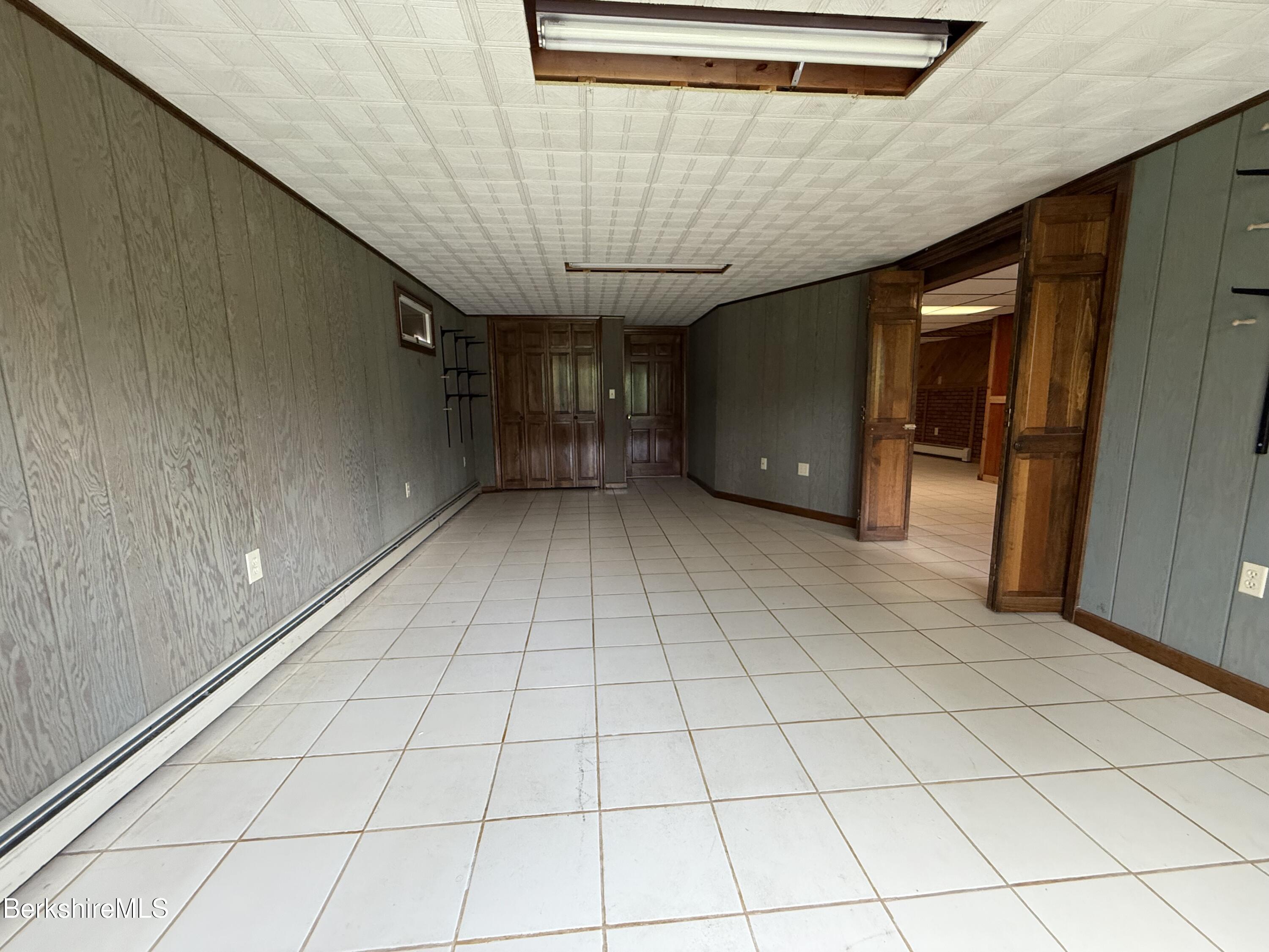 153 East Dugway Road Lenox, MA 01240 - Photo 23 of 26 a view of a livingroom with a white wall and next to a window