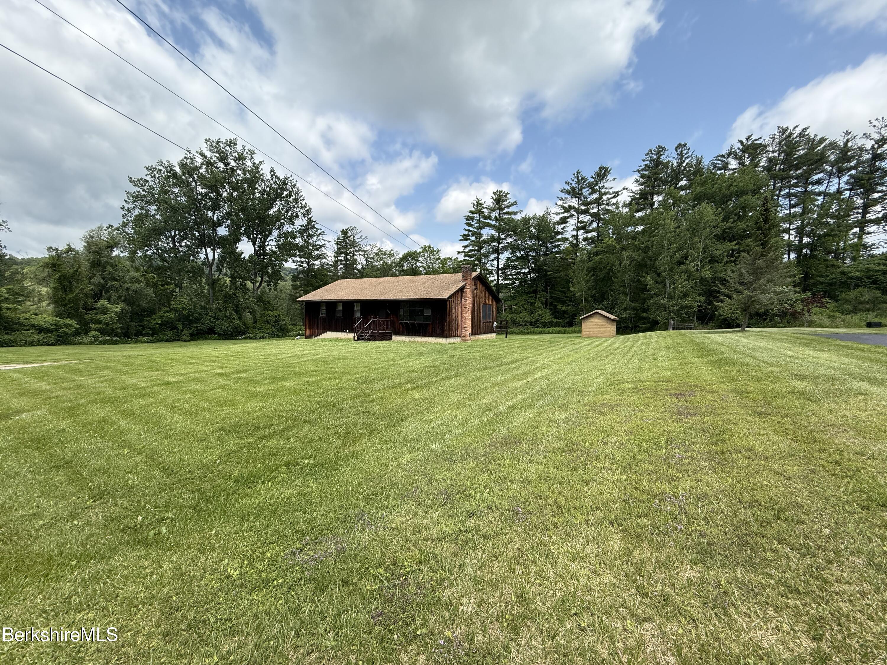 153 East Dugway Road Lenox, MA 01240 - Photo 6 of 26 a view of a garden with a bench