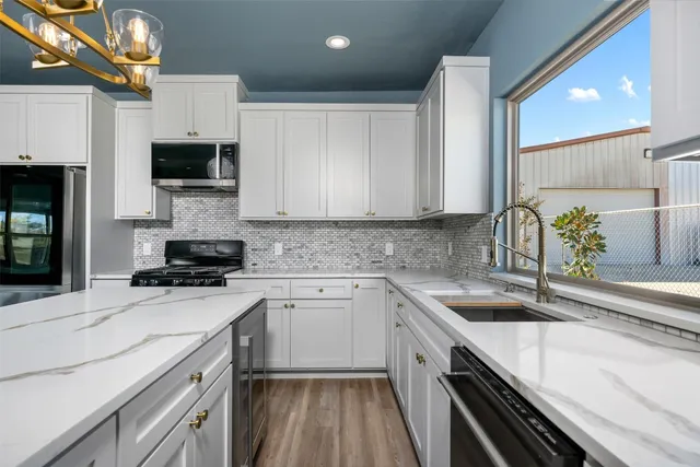 a bathroom with a granite countertop sink a toilet and a mirror