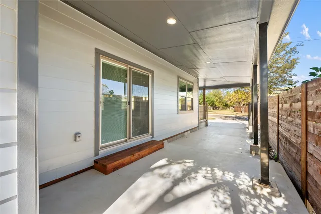 a bathroom with a granite countertop sink a mirror and a toilet