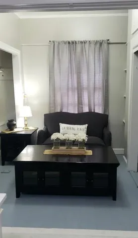 a living room with furniture and a lamp