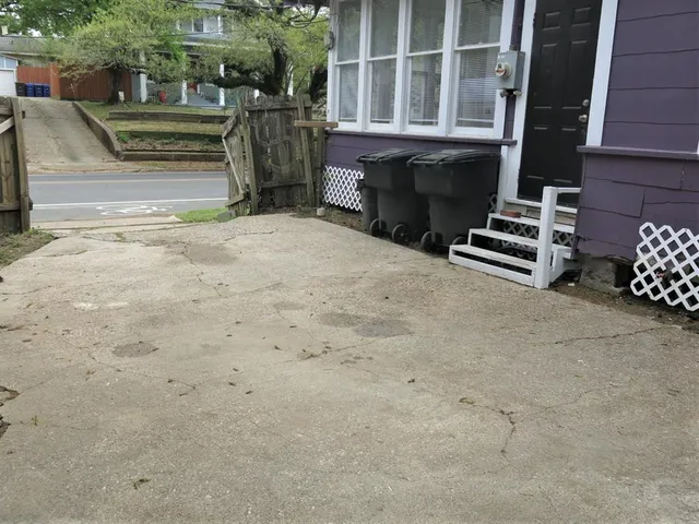 a view of a house with backyard and parking
