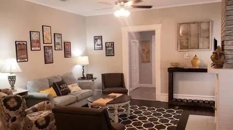 a living room with furniture and wooden floor