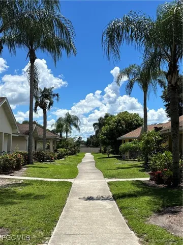 a swimming pool with outdoor seating yard and green space