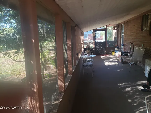 a view of a balcony with chair and glass door