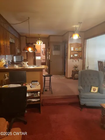 a living room with furniture and chandelier