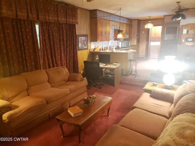 a living room with furniture and a table