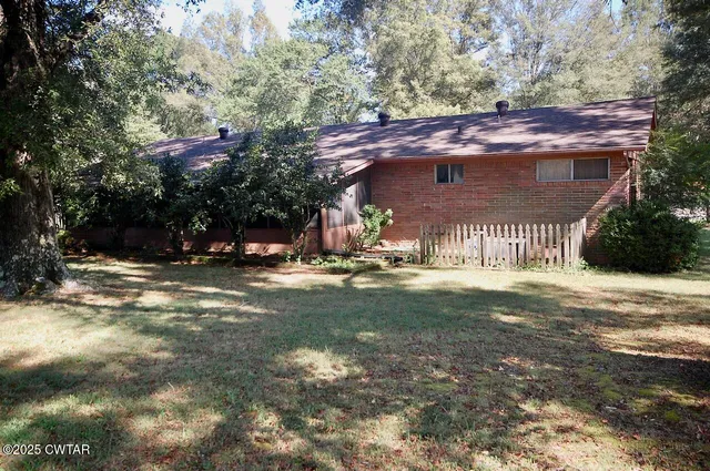 a view of a wooden house with a yard