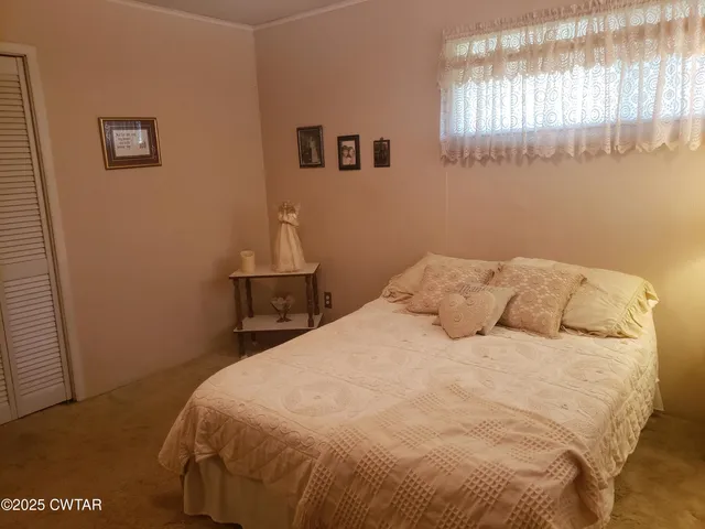 a bed sitting in a room next to a window