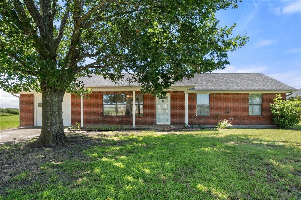 2038 Forreston Road Waxahachie, TX 75165 - Photo 2 of 39 Single story home featuring a shingled roof, a front lawn, and brick siding