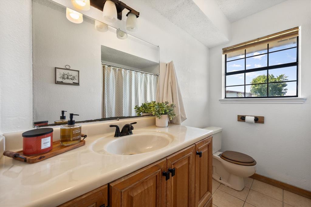 2038 Forreston Road Waxahachie, TX 75165 - Photo 21 of 39 Full bathroom featuring vanity, tile patterned floors, and a shower with curtain