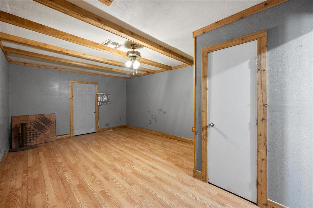 2038 Forreston Road Waxahachie, TX 75165 - Photo 26 of 39 Spare room with wood finished floors, beamed ceiling, and ceiling fan