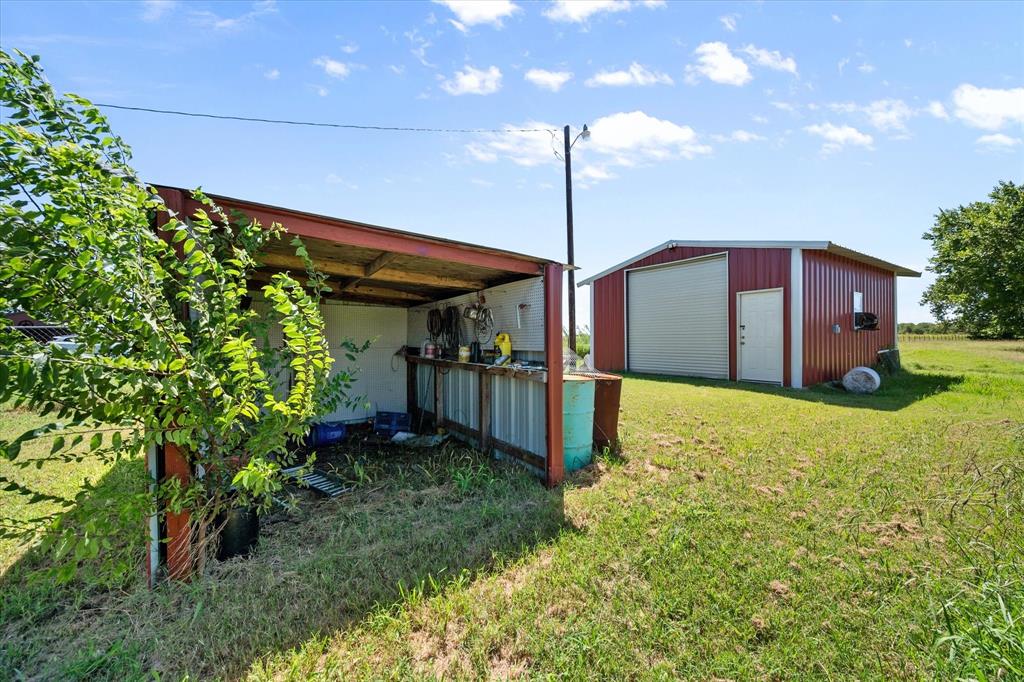 2038 Forreston Road Waxahachie, TX 75165 - Photo 29 of 39 View of grassy yard with a garage and an outdoor structure