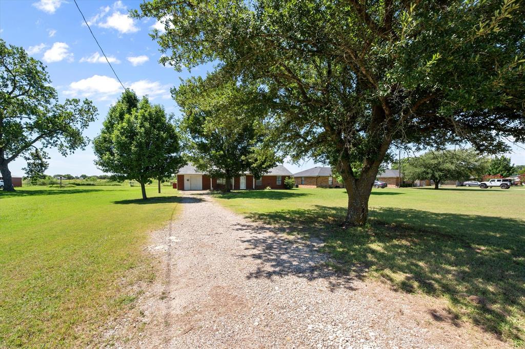 2038 Forreston Road Waxahachie, TX 75165 - Photo 33 of 39 View of front of house featuring gravel driveway and a front lawn