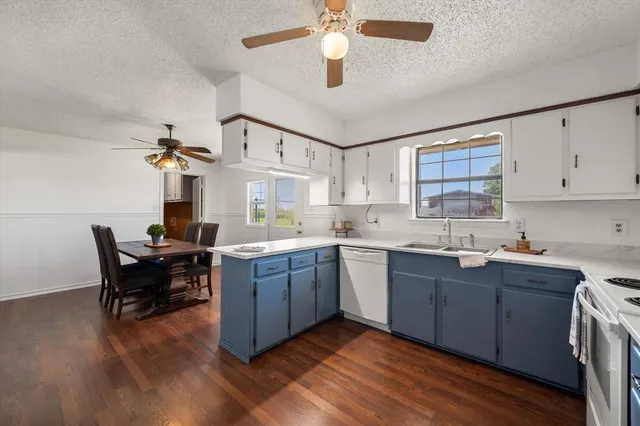 a kitchen with a sink cabinets and wooden floor