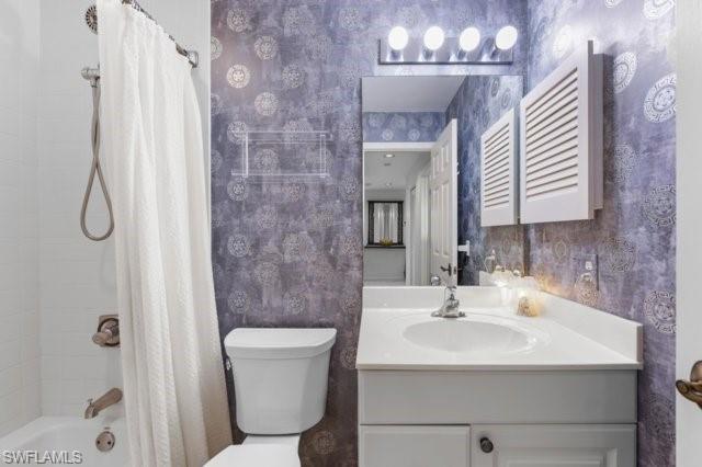 6573 Marissa Loop, Unit 105 Naples, FL 34108 - Photo 23 of 42 a bathroom with a sink a toilet and shower