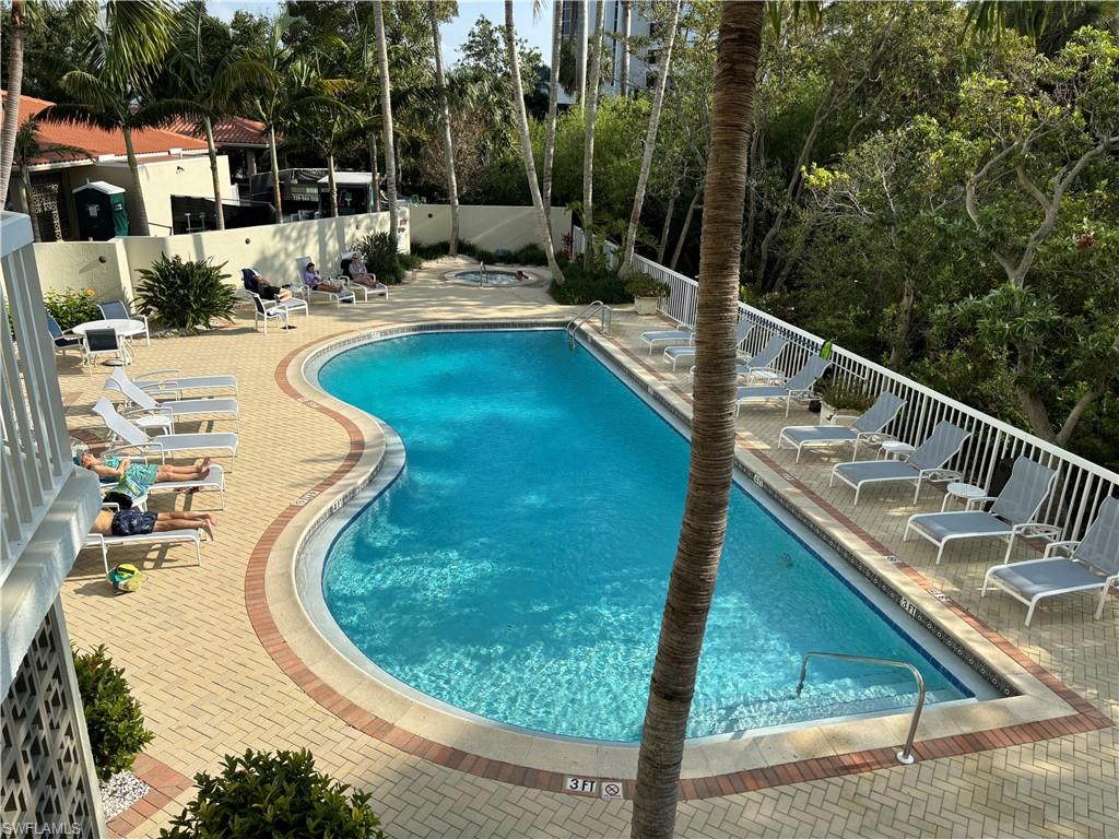 6573 Marissa Loop, Unit 105 Naples, FL 34108 - Photo 31 of 42 a view of a swimming pool with a patio