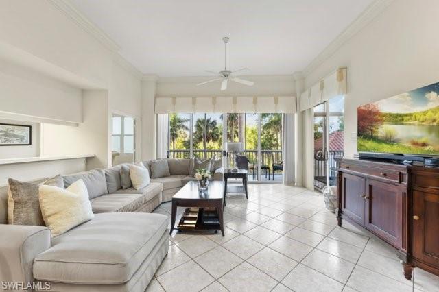 6573 Marissa Loop, Unit 105 Naples, FL 34108 - Photo 5 of 42 a living room with furniture and a flat screen tv