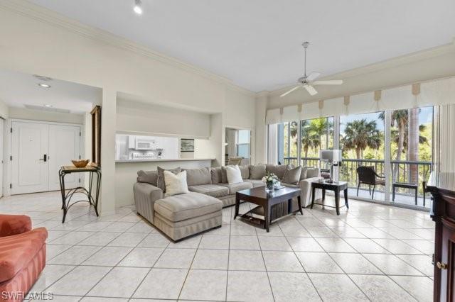 6573 Marissa Loop, Unit 105 Naples, FL 34108 - Photo 6 of 42 a living room with furniture and a large window