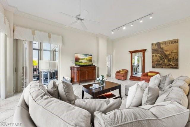 6573 Marissa Loop, Unit 105 Naples, FL 34108 - Photo 9 of 42 a living room with furniture and a large window
