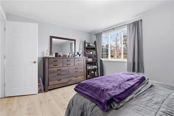 a bedroom with a large bed and a dresser