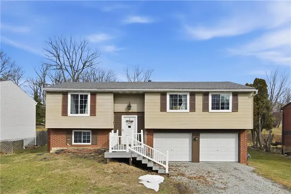 a front view of a house with a yard