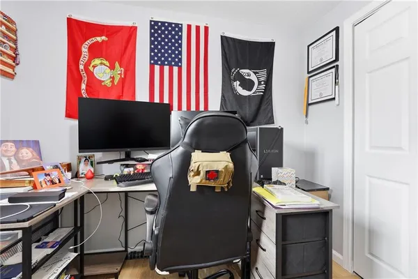 a workspace with furniture and screen flat screen tv