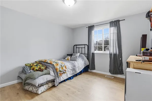 a bedroom with a bed and a tv
