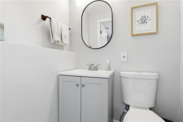 a bathroom with a toilet a sink and a mirror