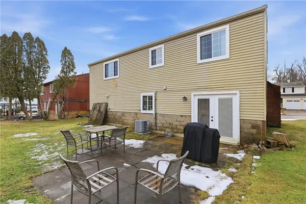 a view of a patio with table and chairs with wooden floor and fence