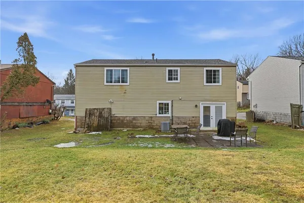 a backyard of a house with table and chairs