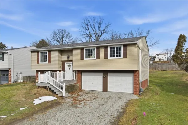 a front view of a house with a yard