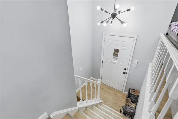 a view of a hallway to a livingroom with furniture
