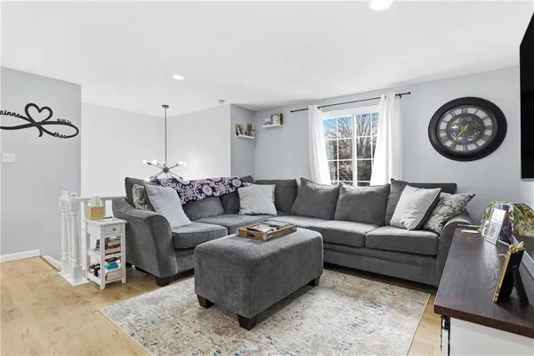 a living room with furniture a clock and a window