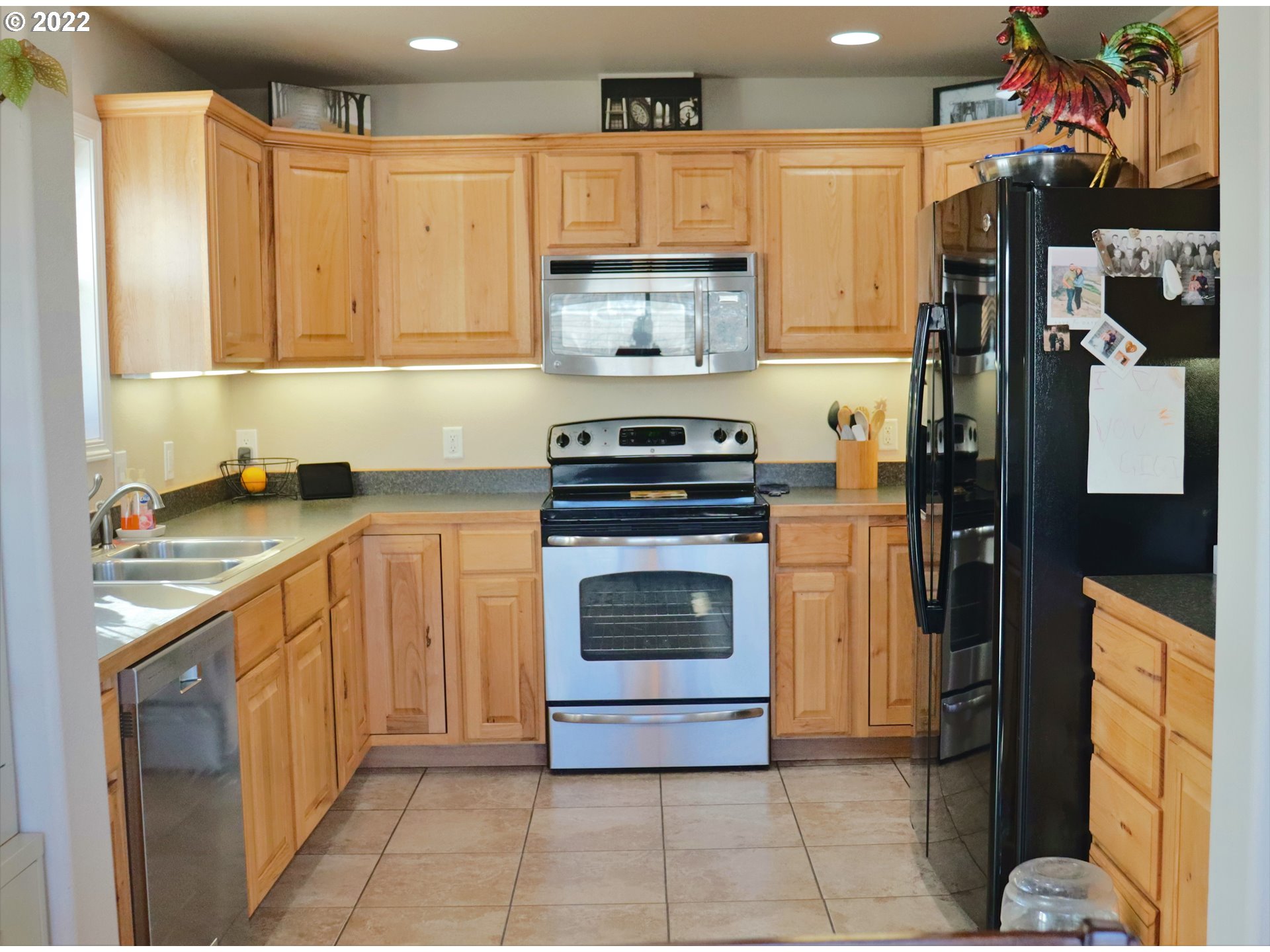 705 L Loop Baker City, OR 97814 - Photo 13 of 32 a kitchen with a stove top oven and cabinets